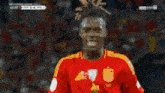 a soccer player wearing a red shirt that says xcl on it