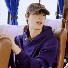 a young man wearing a hat that says i 'm a traveler