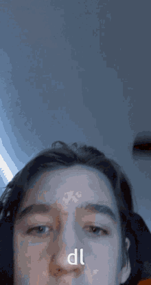 a close up of a person 's face with the letters dl written on it