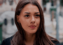 a close up of a woman 's face with her eyes closed