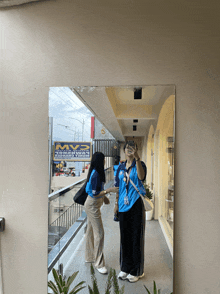 a woman taking a selfie in front of a mvp store