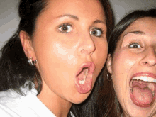 two women are posing for a picture with their mouths open