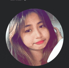 a woman 's face is shown in a purple circle