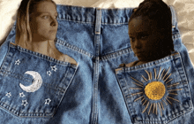 a pair of denim shorts with a crescent moon and stars embroidered on them