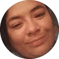 a close up of a woman 's face in a circle with a nose ring