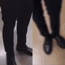a man in a suit and black shoes is walking on a sidewalk .