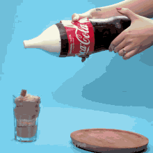 a person is opening a bottle of coca cola on a wooden table