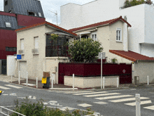 a house with a red fence and a blue sign that says ' a ' on it