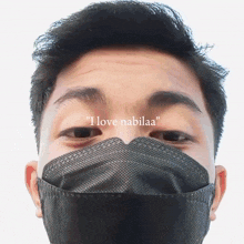 a man wearing a black face mask with the words " i love nabilaa " written above his face