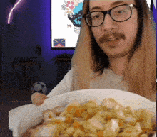 a man wearing glasses and a mustache is holding a bowl of food