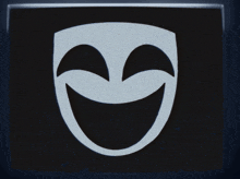 a black and white mask with tears coming out of its eyes
