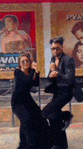 a man and a woman are dancing in front of a poster for a movie called awai