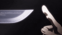 a close up of a person 's finger pointing at a sword with writing on it