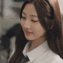 a close up of a girl wearing a headband