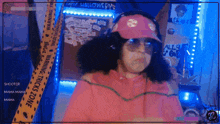 a woman wearing a pink hat and sunglasses is standing in front of a warning tape that says halloween