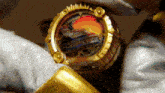 a person is holding a gold item that says ' avengers ' on it
