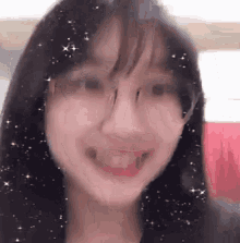 a close up of a woman 's face with stars on it and a smile .