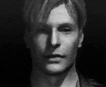 a black and white photo of a man 's face with a shadow on his face .
