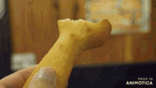 a person is holding a piece of food that says made in animotica