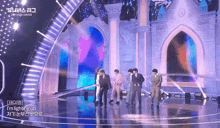 a group of men are standing on a stage with a sign that says i 'm lighting up ..