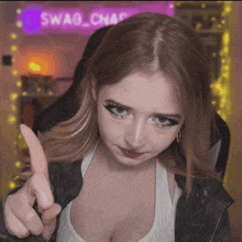 a girl giving a thumbs up in front of a sign that says swag_chas