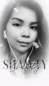 a black and white photo of a woman wearing ear buds and the word beauty on the bottom right