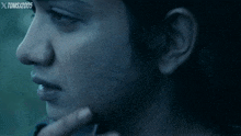a close up of a person 's face with xtoms / 2005 written on the bottom