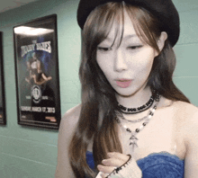 a woman in a blue dress stands in front of a poster for the dobby blues