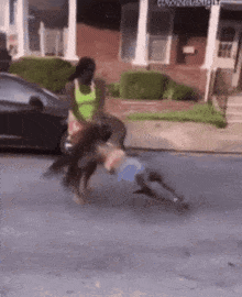 a woman is riding a horse down a street while another woman is riding a bike .