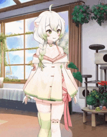 a girl in a white dress is standing in front of a cat tree