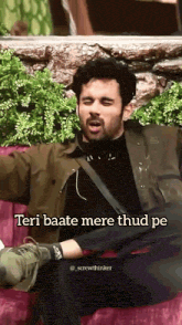 a man is sitting on a couch with his mouth open and a caption that says teri baate mere thud pe