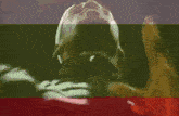 a close up of a person 's face with a green and red background .