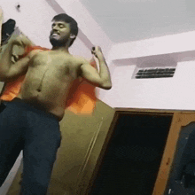 a shirtless man with a beard is dancing in a bedroom