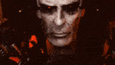 a close up of a man 's face with red eyes .
