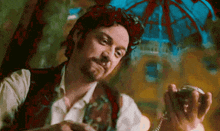 a man with a beard is holding a pocket watch in his right hand