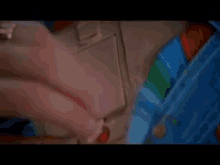 a close up of a person 's hand holding something in their pocket