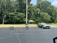 a car is parked in a parking lot next to a tent