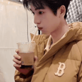 a young man wearing a jacket with the letter b on it