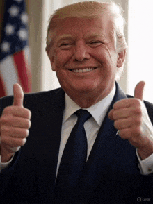 donald trump is smiling and giving two thumbs up in front of an american flag