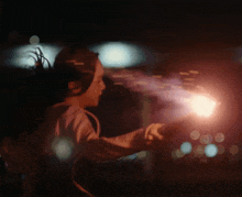 a person is holding a torch in their hand in the dark