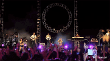 a group of people playing instruments on a stage with a rbd.gif watermark