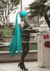a woman in a blue wig is standing in front of a trash can that says hi