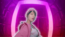 a woman in a pink jacket and a pink hat is standing in front of a pink and purple background .