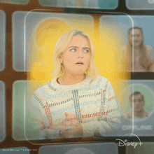 a woman is standing in front of a disney + logo