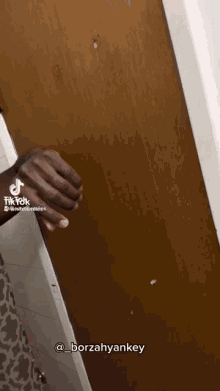 a tiktok video of a person holding a door
