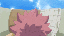 a man with pink hair and a scarf around his neck is smiling