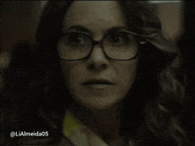 a close up of a woman wearing glasses with the username lialmeida05 below her