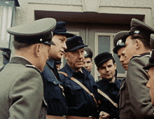 a group of men in military uniforms are standing in a line