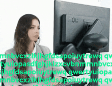 a woman sitting in front of an aoc computer monitor