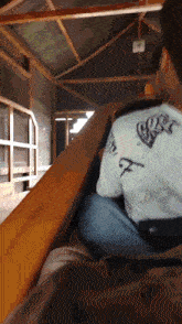 a man wearing a white shirt with the letter f on the back is riding a roller coaster